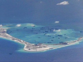 Chinese dredging vessels are purportedly seen in the waters around Mischief Reef in the disputed Spratly Islands in the South China Sea, in this file still image from video taken by a P-8A Poseidon surveillance aircraft and provided by the United States Navy on May 21, 2015. Japan will join a major U.S.-Australian military exercise for the first time in a sign of growing security links between the three countries as tensions fester over China's island building in the South China Sea. REUTERS/U.S. Navy/Handout via Reuters/Files