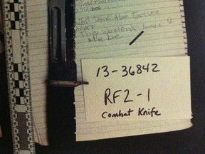 This photo of a bloody combat knife was entered into evidence Tuesday at the second-degree murder trial of Mark Haslett, 27, who is accused in the stabbing death of roommate Rolande Laflamme, 54, on Feb. 11, 2013. (HANDOUT)