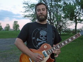 Dave Nadeau thought he had lost his $2,500 Gibson Les Paul after a Blue Line cabbie drove off with it at around 3:30 a.m. on May 19. But the company located the guitar and returned it back to Nadeau on Wednesday, May 27/ 2015. (Keaton Robbins/Ottawa Sun)