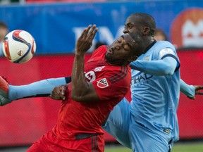 TFC’s Bright Dike battles for the ball against Manchester City’s Yaya Toure during at BMO Field last night. Man City won 1-0. (Craig Robertson/Toronto Sun)