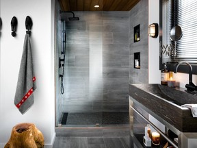 Grey-coloured tile in slab form for the walls of the shower and a mini-hexagonal mosaic for the floor create a slick and fresh look.