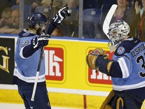 Rimouski Oceanics Guillaume McSween (68) and goalie Philippe Desrosiers celebrate their victory against the Quebec Remparts during their Memorial Cup hockey game at the Colisee Pepsi in Quebec City, May 27, 2015. REUTERS/Mathieu Belanger