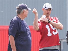 Argos QB Ricky Ray shows GM Jim Barker the range of motion in his surgically repaired shoulder yesterday at York University. Ray’s return date is unknown, but he could miss as many as the first five games.  (VERONICA HENRI, Toronto Sun)