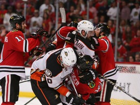 Chicago Blackhawks centre Marcus Kruger is brought down by Anaheim Ducks right winger Corey Perry during the third period of Game 6 of the Western Conference final of the 2015 NHL playoffs at United Center on May 27, 2015. (Caylor Arnold/USA TODAY Sports)