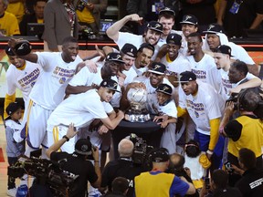 Golden State Warriors players celebrate with the western conference championship trophy after defeating the Houston Rockets in Game 5 of the Western Conference Finals of the NBA playoffs at Oracle Arena on May 27, 2015. (Kelley L Cox/USA TODAY Sports)