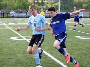 Alain Huneault, left, of St. Benedict Bears, and Noah Lasorsa, of College Notre-Dame, battle for possession of the ball during the senior boys high school soccer premier final at James Jerome Sports Complex in Sudbury, Ont. on Wednesday May 27, 2015. John Lappa/Sudbury Star/Postmedia Network