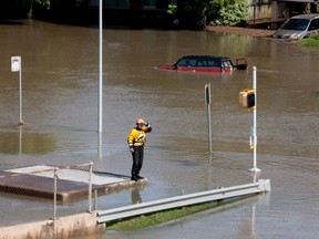 A rescue worker scans a flooded area in south Houston, Texas May 26, 2015. REUTERS/Daniel Kramer