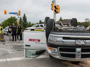 Emergency services personnel at the scene of a serious collision between two vehicles at the intersection of Earl Armstrong Road and Spratt Road in Ottawa on Thursday May 28, 2015. Errol McGihon/Ottawa Sun/Postmedia Network