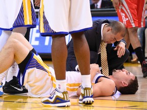 Golden State Warriors guard Klay Thompson (11) lays injured during the fourth quarter against the Houston Rockets in game five of the Western Conference Finals of the NBA Playoffs at Oracle Arena. (Kyle Terada-USA TODAY Sports)
