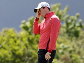 Northern Ireland golfer Rory McIlroy reacts after missing his putt shot on the 9th green on the first day of the Irish Open at the Royal County Down Golf Club in Newcastle in Northern Ireland on May 28, 2015. AFP PHOTO/Paul Faith