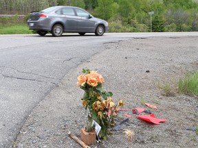 Flowers sit on the side of Municipal Road 55 in Naughton, Ont. near the location of a fatal accident on May 22, 2015. Steve Loebach, who was in his mid-20s, was driving an all-terrain vehicle eastbound when a westbound vehicle struck him head-on Greater Sudbury Police said. John Lappa/Sudbury Star/Postmedia Network
