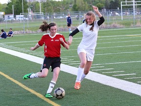 Stephanie Martin, left, of St. Charles Cardinals, and Hope Joly, of Marymount Regals, fight for the ball during the open girls premier high school soccer finals at James Jerome Sports Complex in Sudbury, Ont. on Wednesday May 27, 2015. John Lappa/Sudbury Star/Postmedia Network