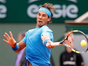 Rafael Nadal of Spain plays a shot to compatriot Nicolas Almagro during their men's singles match at the French Open tennis tournament at the Roland Garros stadium in Paris, France, May 28, 2015.           (REUTERS/Vincent Kessler)