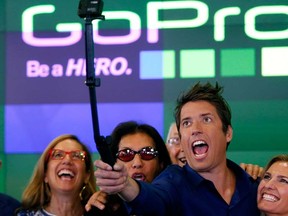 GoPro Inc.'s founder and CEO Nick Woodman (C) celebrates GoPro Inc's IPO with family and staff at the Nasdaq Market Site in New York City, June 26, 2014. REUTERS/Mike Segar