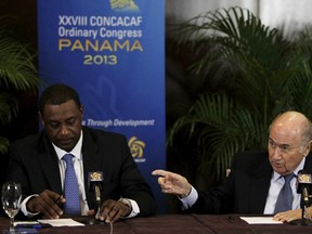 FIFA President Joseph "Sepp" Blatter, right, gestures next to CONCACAF President Jeffrey Webb in this April 19, 2013 file photo. CONCACAF has announced that Webb and Eduardo Li have been dismissed and named Senior Vice President Alfredo Hawit as president. Webb and Li were among seven FIFA officials arrested May 27 on suspicion of corruption. REUTERS/Carlos Jasso/Files