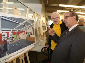 JASON MILLER/THE INTELLIGENCER
Historian Gerry Boyce and Coun. Garnet Thompson examine drawings showing the layout of the new community archives soon to be housed at the library.