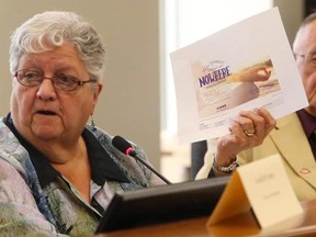 Luke Hendry/The Intelligencer
Bancroft Mayor Bernice Jenkins shows fellow Hastings County councillors a new regional tourism advertisement from Ontario's Highlands Tourism Organization during a county council meeting in Belleville Thursday. The ad refers to some rural municipalities as being "nowhere" and Jenkins said that's insulting. At right is Centre Hastings Mayor Tom Deline.