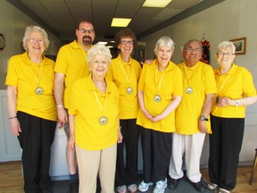 Members of the Sarnia White Cane Bowlers on Thursday May 28, 2015 in Sarnia, Ont.,  model gold medals they earned as champions of a recent tournament. From left, coach Irene Toren, Geoff Kidd, Sophie Jackson, Joan Capp, Ann Smith, Randy Bird and Amelia Uchacz. Paul Morden/Sarnia Observer/Postmedia Network