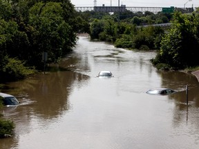 Flood waters cover several cars on the South I-610 frontage road in Houston, Texas on May 26, 2015. (REUTERS/Daniel Kramer)