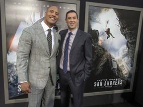 Director of the movie Brad Peyton (R) and cast member Dwayne Johnson pose at the premiere of "San Andreas" in Hollywood, California May 26, 2015. The movie opens in the U.S. on May 29.  REUTERS/Mario Anzuoni