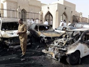 A policeman carries out an inspection after a car exploded near the Shi'ite al-Anoud mosque mosque in Saudi Arabia's Dammam May 29, 2015.    REUTERS/Faisal Al Nasser