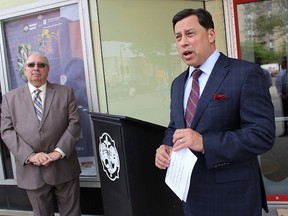 Brad Duguid, Minister of Economic Development, Employment and Infrastructure, announces plans for a new provincial accessibility certification program outside Sarnia's Imperial Theatre Friday. Pictured with him is Sarnia-Lambton MPP Bob Bailey. Duguid was also in Sarnia for the city's second annual Accessibility Summit, and was meeting with local manufacturing sector representatives. Tyler Kula/Sarnia Observer/Postmedia Network