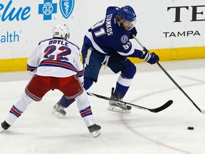 Lightning centre Steven Stamkos (right) carries the puck past Rangers defenceman Dan Boyle (22) during Game 4 action in the Eastern Conference final in Tampa, Fla. The series will be decided tonight in New York in Game 7. (Reinhold Matay/USA TODAY Sports)