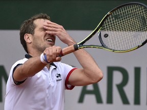 France’s Richard Gasquet reacts during his match against Argentina’s Carlos Berlocq during the second round of the French Open Friday at Roland Garros in Paris. (AFP PHOTO/DOMINIQUE FAGET)
