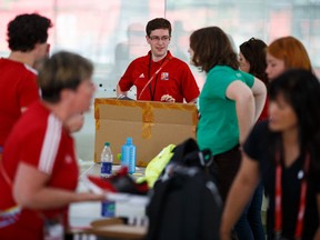 FIFA volunteers pick up their packages at Commonwealth Community Rec Centre in Edmonton, Alta., on Thursday May 28, 2015. Volunteers are getting ready to help out with the FIFA Women's World Cup Canada 2015. Ian Kucerak/Edmonton Sun