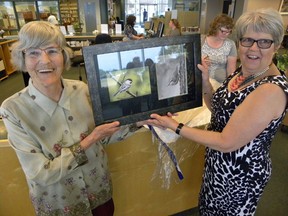 Ernst Kuglin/The Intelligencer
Library board chair Judy VanLeeuwen presents Ann Andeweg (right) with a signed print by well-known Quinte region artist Doug Comeau. Andeweg's last day at the Quinte West Public Libray was Friday, capping a 39-year career.
