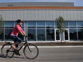 Luke Hendry/The Intelligencer
Health promoter Tanya Hill rides past the Hastings Prince Edward Public Health office in Belleville Friday. She's co-ordinating the fourth-annual Quinte Commuter Challenge, which begins May 31.