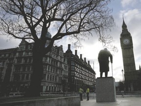 A statue of former British Prime Minister Winston Churchill and the Big Ben clocktower are silhouetted against the morning sky in central London, England, earlier this month. (Stefan Wermuth/Reuters)