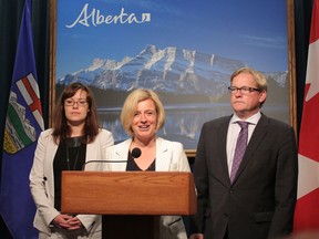 Alberta Premier Rachel Notley speaks in a press conference at the McDougall Centre flanked by Justice/Aboriginal Affairs Minister Kathleen Ganley and Education/Culture and Tourism Minister David Eggen in Calgary, Ab., on Thursday May 28, 2015. Mike Drew/Calgary Sun/Postmedia Network
