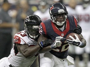 Ronnie Brown (right) of the Houston Texans is tackled by Prince Shembo of the Atlanta Falcons during a pre-season NFL game on August 16, 2014 at NRG Stadium in Houston. (Bob Levey/Getty Images/AFP)