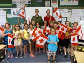Captain Derek (left, back) dropped by his childhood best friend Joe Turner's (right, back) grade 3/4 class at Mooretown Public School to thank them for the letters they sent him while deployed. (Chris O’Gorman, The Observer)