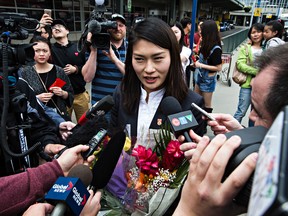 Chinese goalkeeper Wang Fei talks to the medias following Team China's arrival at the edmonton International Airport. (Codie McLachlan, Edmonton Sun)