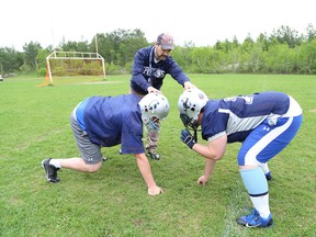 Sudbury Spartans head coach Junior Labrosse, middle, works Andrew Gillis, left, and Nickolas Labrosse at a practice on Friday night. John Lappa/The Sudbury Star