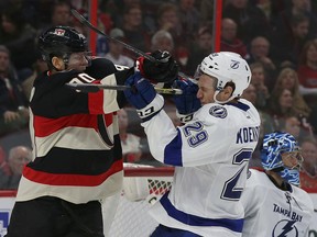 Ottawa Senators forward Alex Chiasson battle Tampa Bay Lightning defenceman Slater Koekkoek during NHL action at the Canadian Tire Centre in Ottawa April 2,  2015. (Tony Caldwell/Ottawa Sun/QMI Agency)