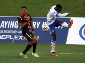 Ottawa Fury FC forward Paulo Jr. dodges a shot by FC Edmonton's Lance Laing Friday, May 29, 2015 as the teams clashed at TD Place. (Chris Hofley/Ottawa Sun)