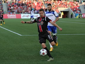 Ottawa Fury FC midfielder Nicki Paterson is pursued by FC Edmonton's Richie Jones Friday, May 29, 2015 as the teams clashed at TD Place. (Chris Hofley/Ottawa Sun)