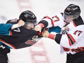Quebec Remparts Yanick Turcotte (R) fights with Kelowna Rockets Rodney Southam (L) during the first period of their semi-final Memorial Cup hockey game at the Colisee Pepsi in Quebec City, May 29, 2015. (DIDIER DEBUSSCHERE, Postmedia Network)