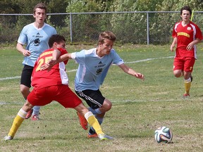 Mattathias Meney, left, of Chippewa Raiders, and Brandon Moxam, of St. Benedict Bears, battle for possession of the ball at the senior boys soccer NOSSA A final at the Howard Armstrong Complex in Hanmer, Ont. on Friday May 29, 2015. John Lappa/Sudbury Star/Postmedia Network