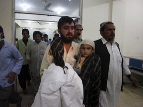Relatives carry a boy who survived an attack on buses, into a hospital in Quetta, Pakistan, late May 29, 2015. REUTERS/Naseer Ahmed