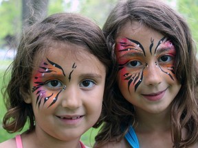 Sisters Ciara, 6 (left), and Kayla, 7, channel their inner butterflies at the second annual Wings of Serenity Butterfly release for the Bereaved Families of Ontario and Hospice Kingston at City Park in Kingston, Ont. on Saturday May 30, 2015. Steph Crosier/Kingston Whig-Standard/Postmedia Network
