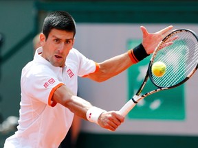 Novak Djokovic of Serbia plays a shot to Thanasi Kokkinakis of Australia during their French Open match at the Roland Garros stadium in Paris May 30, 2015. (REUTERS/Pascal Rossignol)