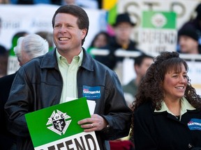 Jim Bob Duggar (L) and his wife Michelle Duggar (R), supporters of Republican presidential candidate and former Pennsylvania Senator Rick Santorum, attend a Pro-Life rally  in Columbia, South Carolina, on the steps of the State House in this file photo from January 14, 2012.  REUTERS/Chris Keane/Files