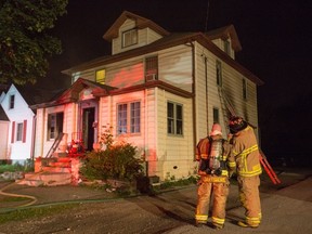 Sarnia firefighters tend to the scene of a triplex fire near the intersection of College Avenue and Wellington Street early Saturday morning. Sarnia police and the Ontario Fire Marshal's Office have been called in to investigate the blaze. PHOTO COURTESY OF FREELANCE PHOTO JOURNALIST TROY SHANTZ