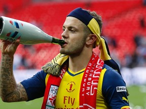 Arsenal’s Jack Wilshere celebrates with champagne after beating Aston Villa 4-0 in the FA Cup final Saturday at Wembley Stadium in London. (Reuters/Carl Recine)