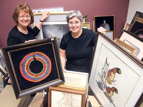 Grands'n'More volunteers Wilma Sotas (l) and Judy Cumberford display art in Winnipeg, Man. Monday May 25, 2015 for the Art From the Attic show.