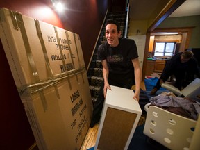 Eric Lafontaine with Highland Moving works with a crew to pack a moving truck with a homeowners belongings near 125 Street and 107 Avenue in Edmonton, Alta., on Friday, Jan. 16, 2015. Ian Kucerak/Edmonton Sun/